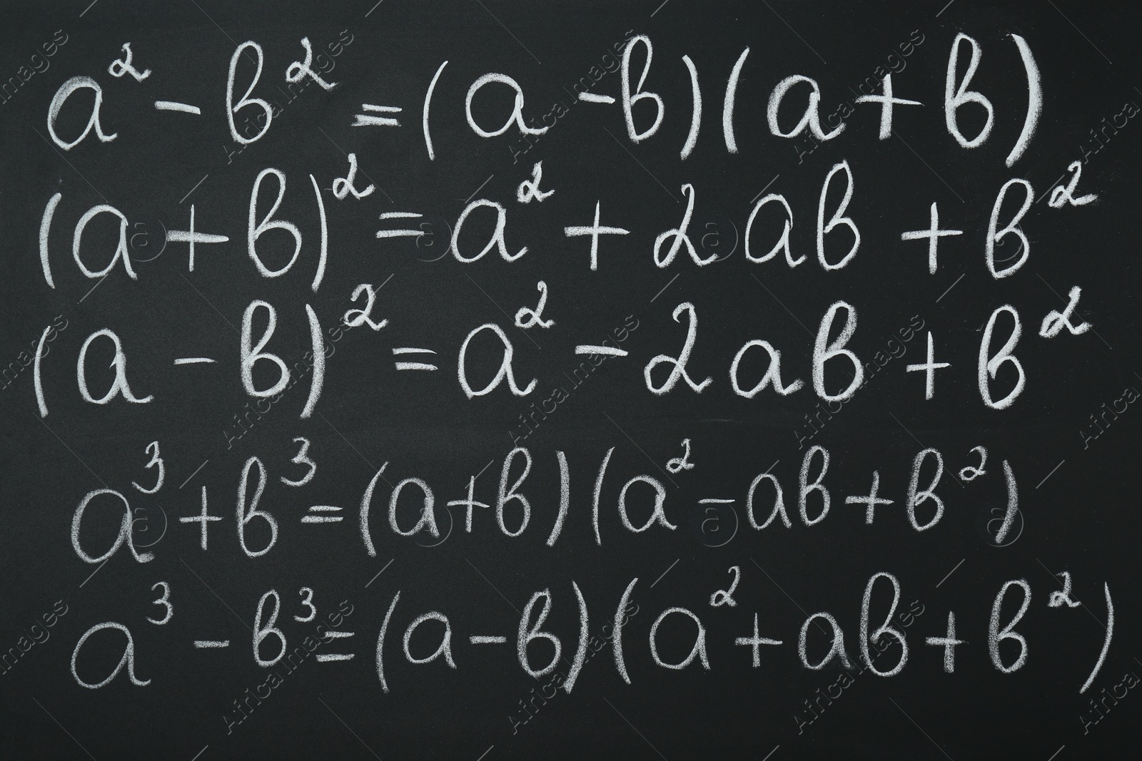 Photo of Many different math formulas written on chalkboard, closeup