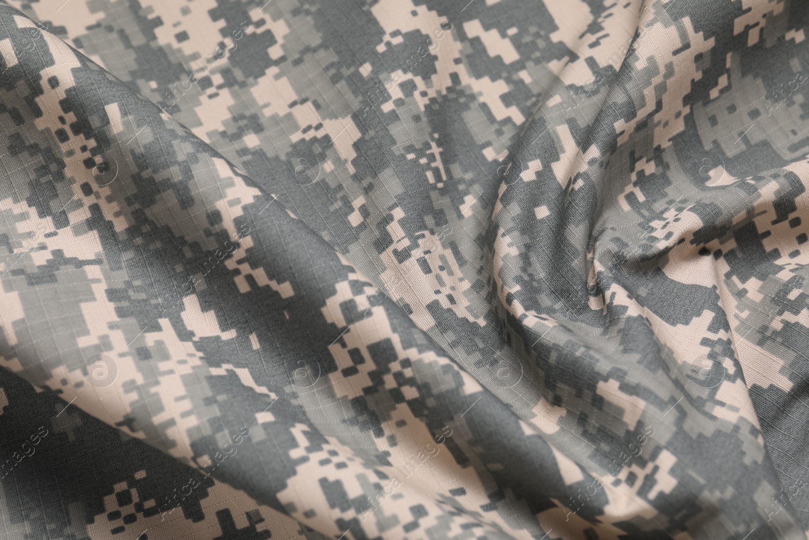 Photo of Texture of crumpled camouflage fabric as background, closeup