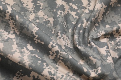 Texture of crumpled camouflage fabric as background, closeup