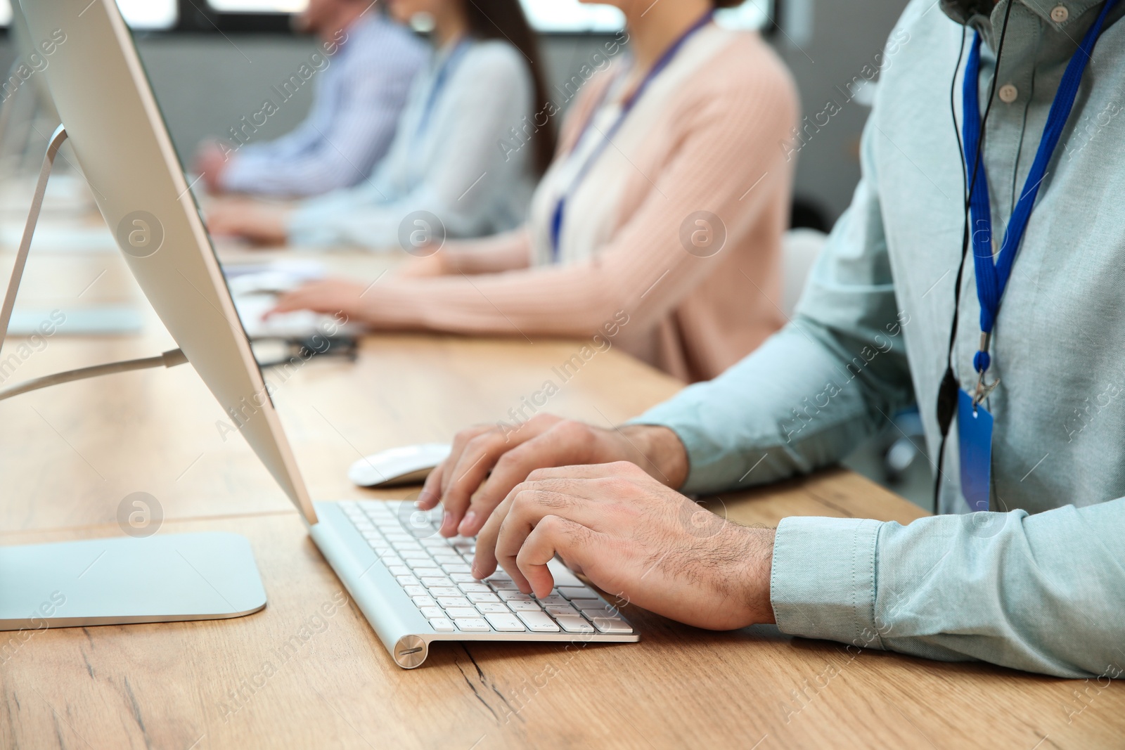 Photo of Technical support operator working at table in modern office, closeup