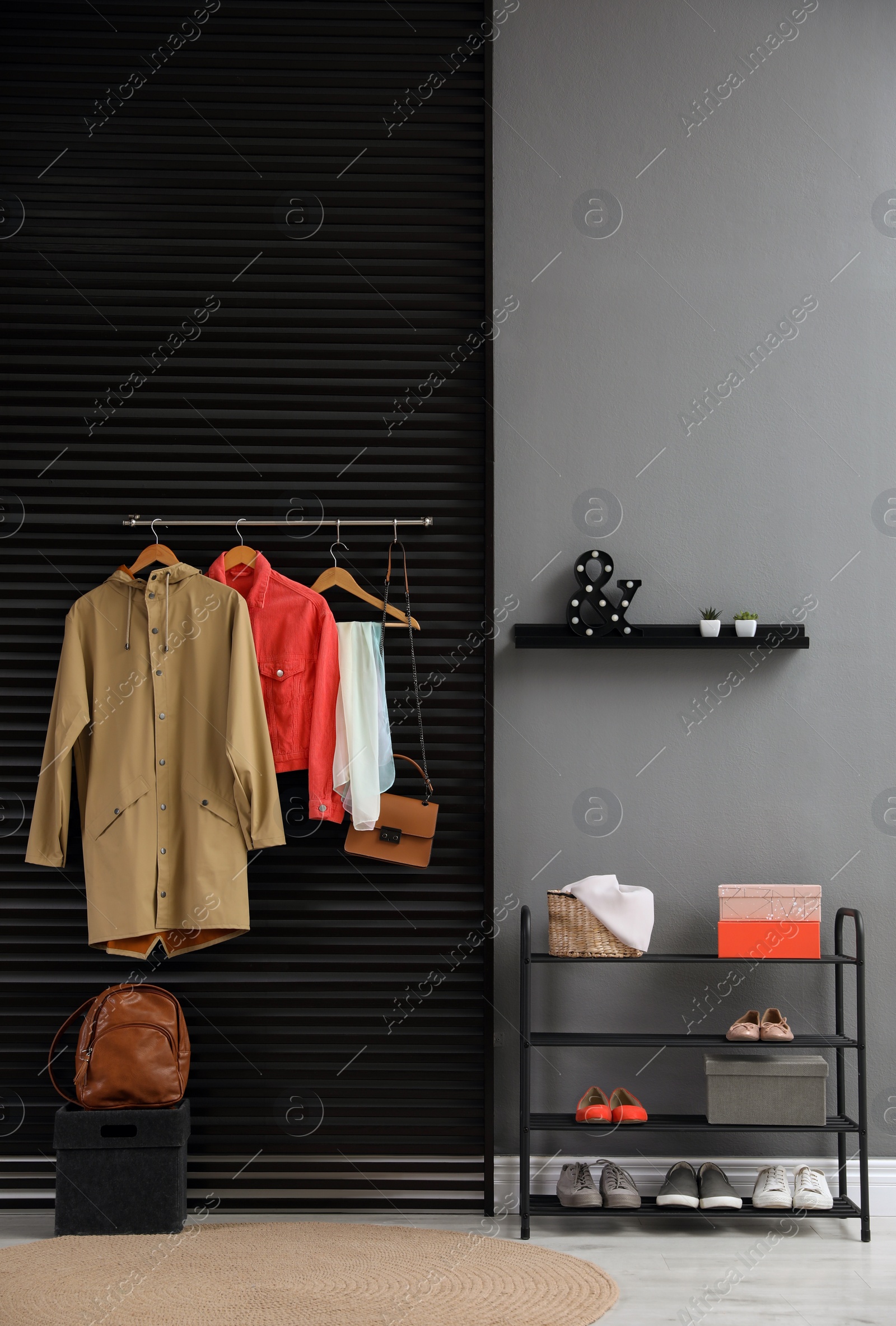 Photo of Hallway interior with stylish furniture, clothes and accessories