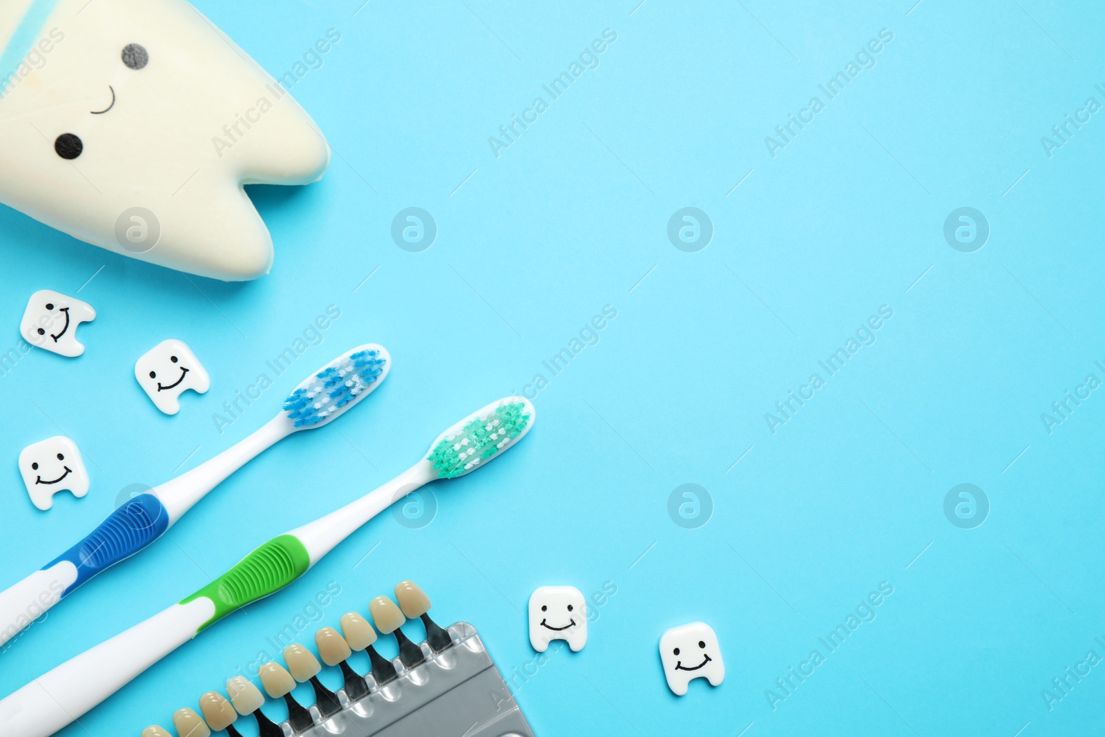 Photo of Flat lay composition with toothbrushes on light blue, space for text