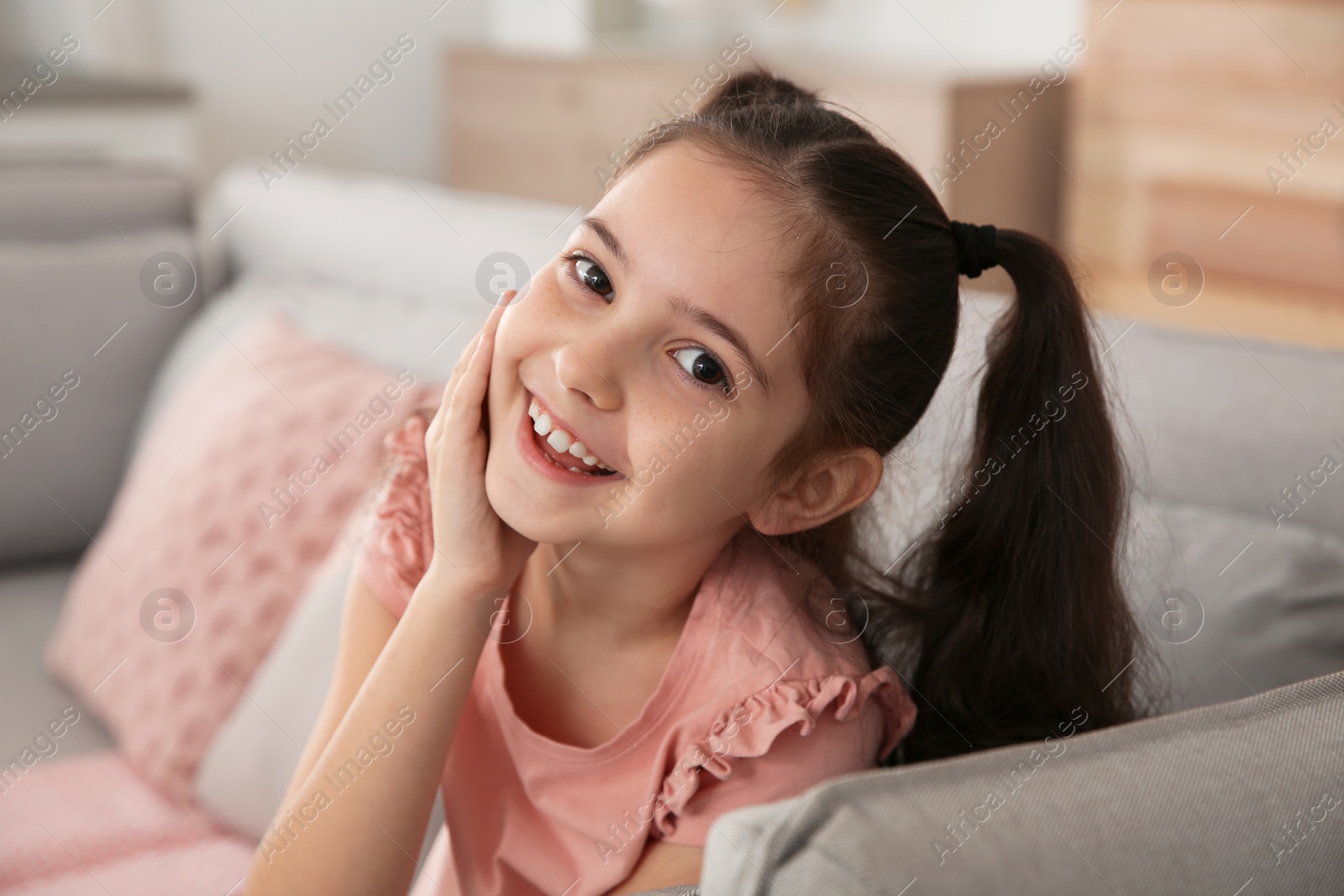 Photo of Portrait of little girl laughing at home