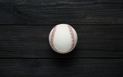 Photo of Baseball ball on black wooden table, top view. Sports game