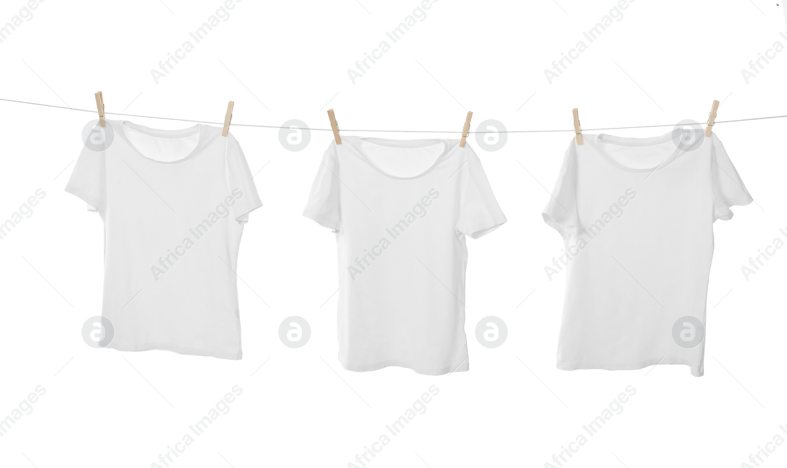 Photo of Many t-shirts drying on washing line isolated on white