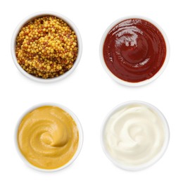 Set of different sauces in bowls isolated on white, top view