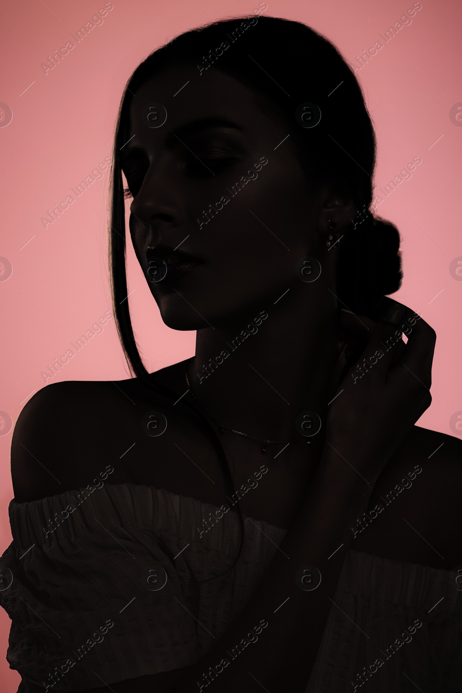 Image of Silhouette of one woman on pink background