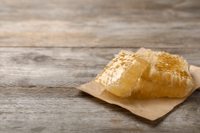 Photo of Fresh honeycomb on wooden table, closeup