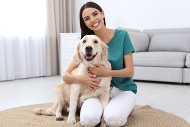 Image of Happy woman with her cute pet dog at home