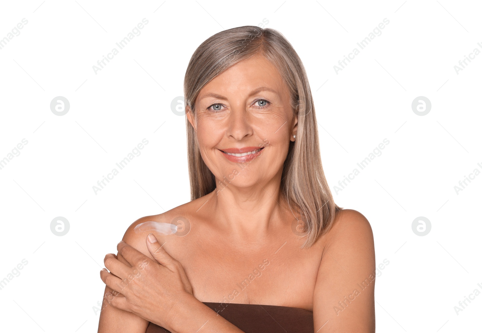 Photo of Beautiful senior woman applying sun protection cream onto her shoulder isolated on white