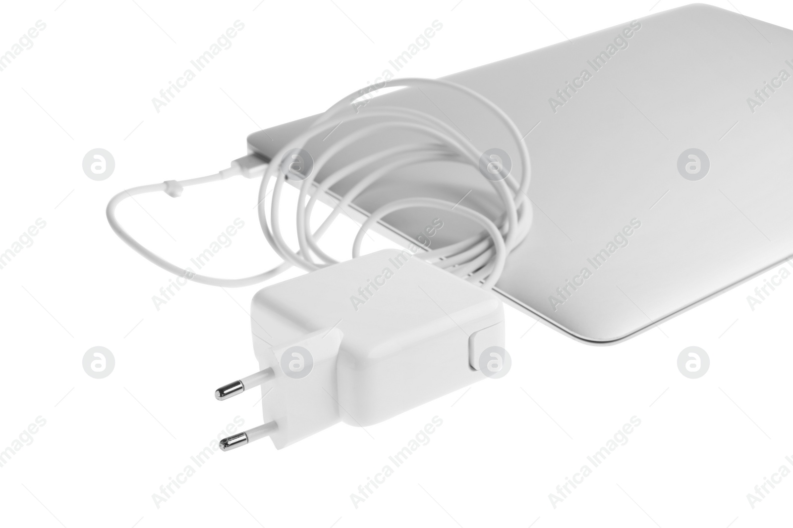 Photo of Laptop and charger on white background. Modern technology