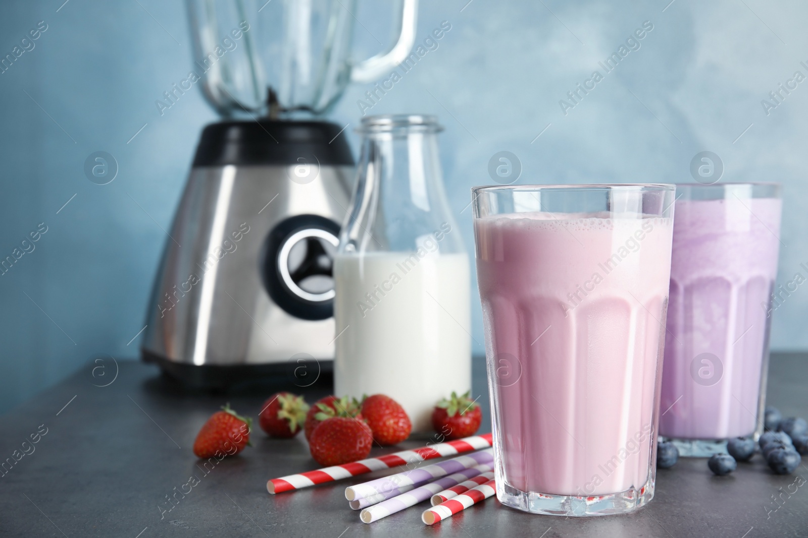 Photo of Delicious milk shakes and ingredients on table