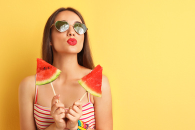 Image of Beautiful young woman wearing sunglasses with reflection of palm trees on yellow background, space for text  