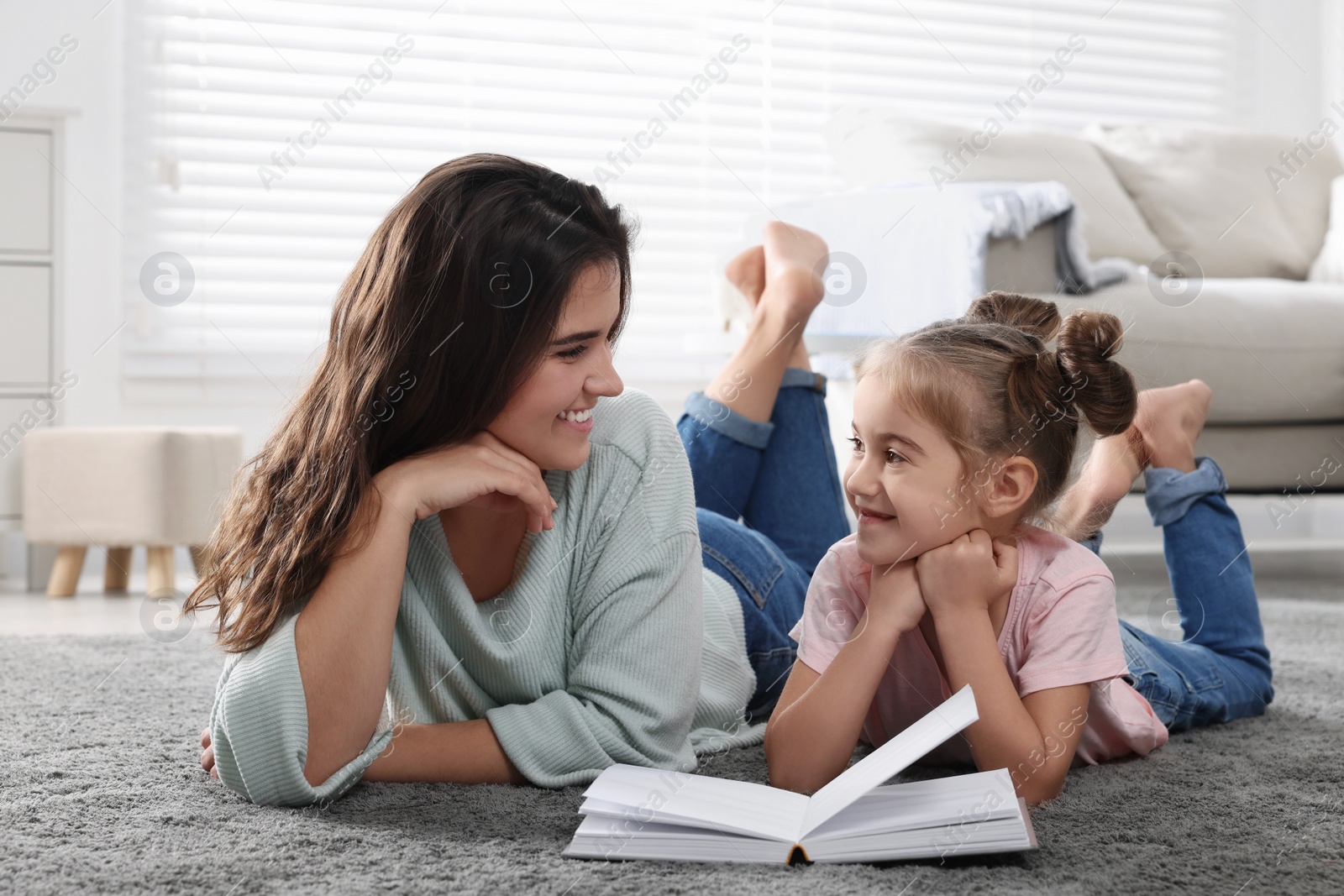 Photo of Young mother and her daughter spending time together at home