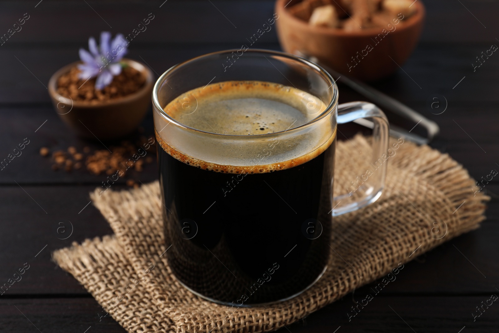 Photo of Glass cup of delicious chicory drink on wooden table, closeup