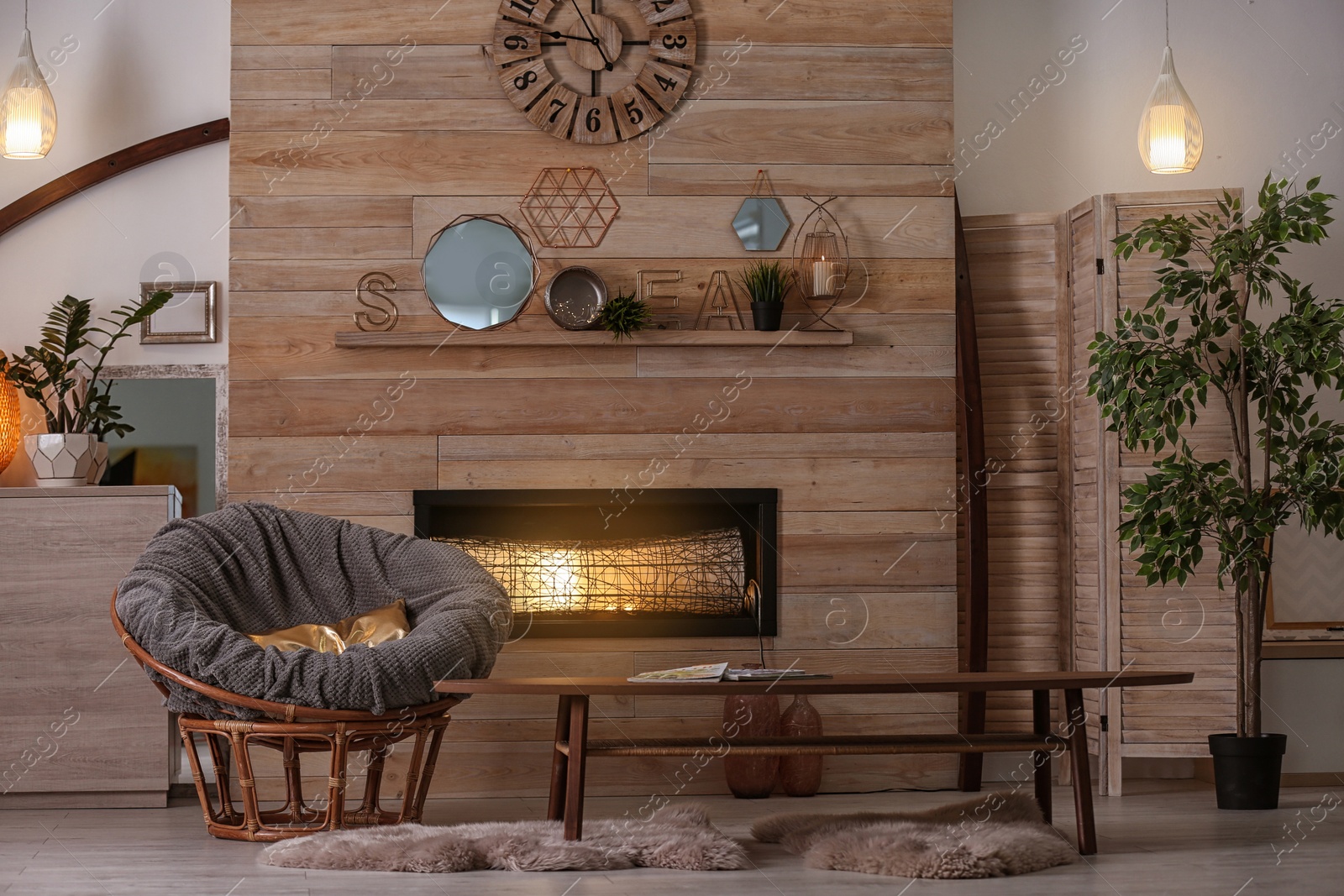 Photo of Cozy living room interior with comfortable papasan chair and decorative fireplace