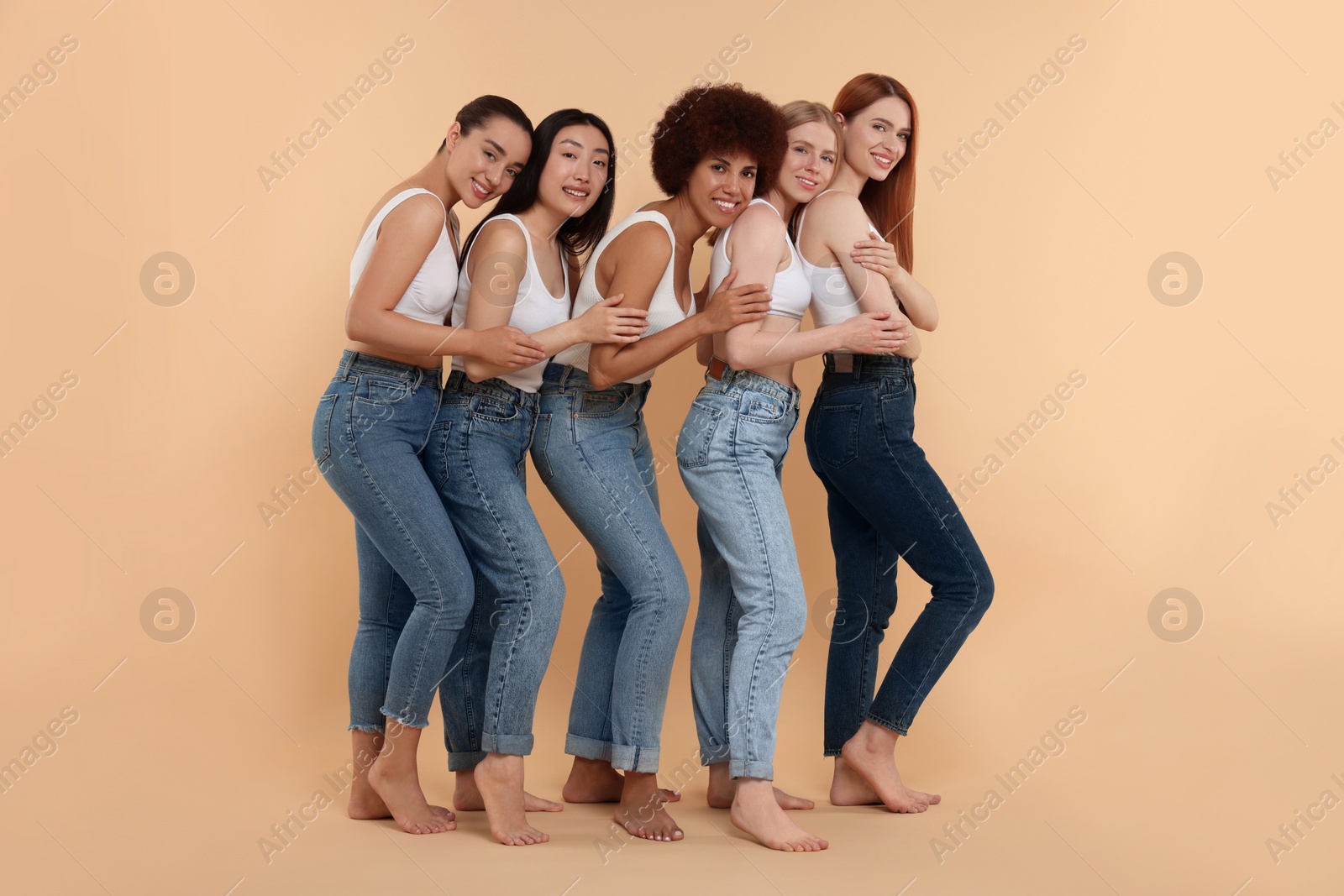 Photo of Group of beautiful young women on beige background