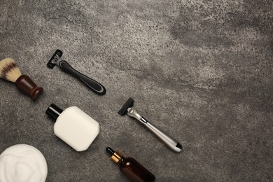 Photo of Flat lay composition with shaving accessories for men on grey table. Space for text