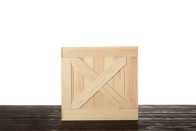 Wooden crate on table against white background