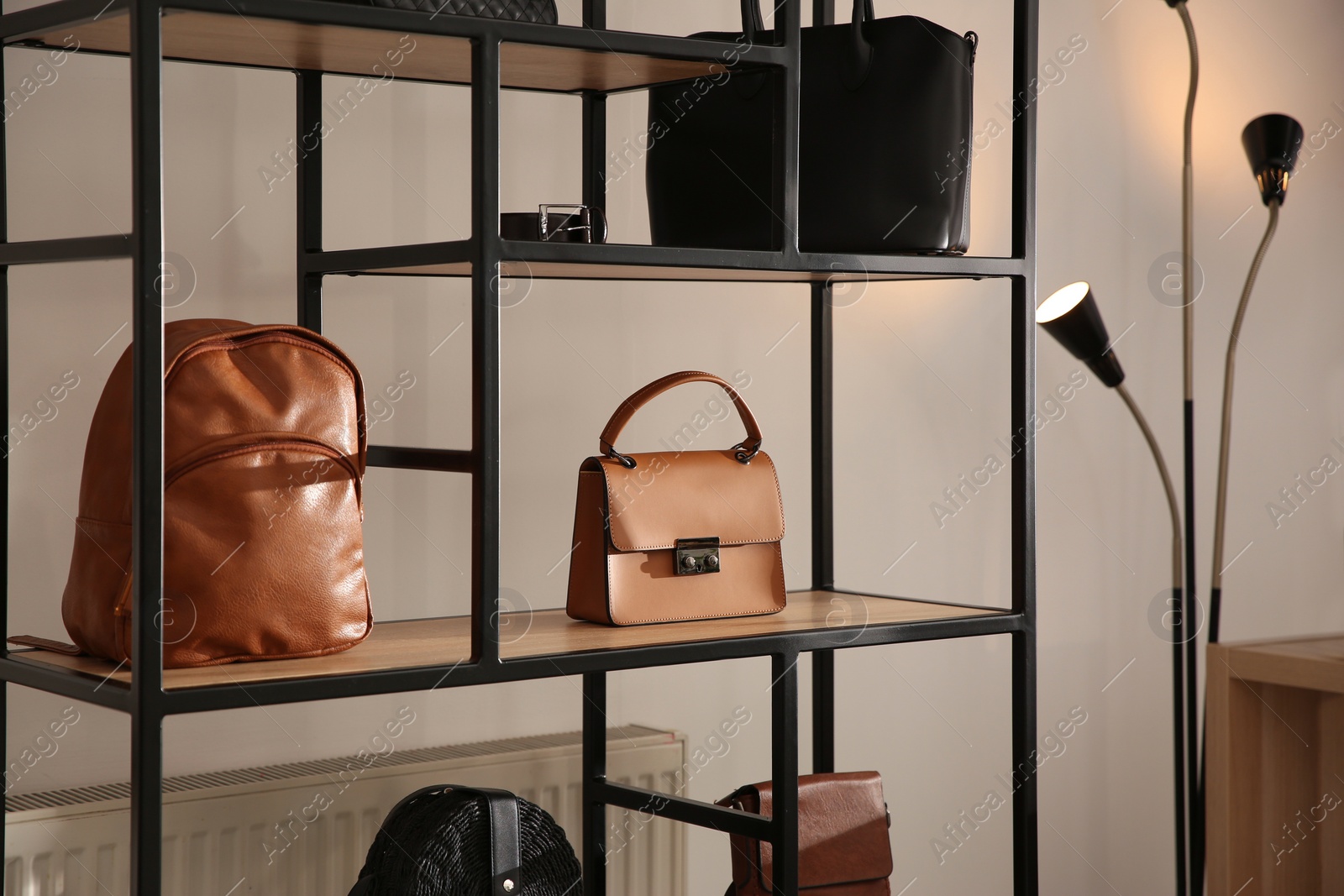 Photo of Collection of stylish women's bags and accessories in luxury boutique