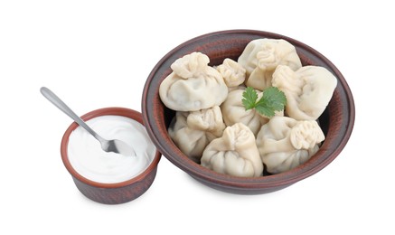 Photo of Tasty khinkali (dumplings) with sauce and parsley isolated on white. Georgian cuisine