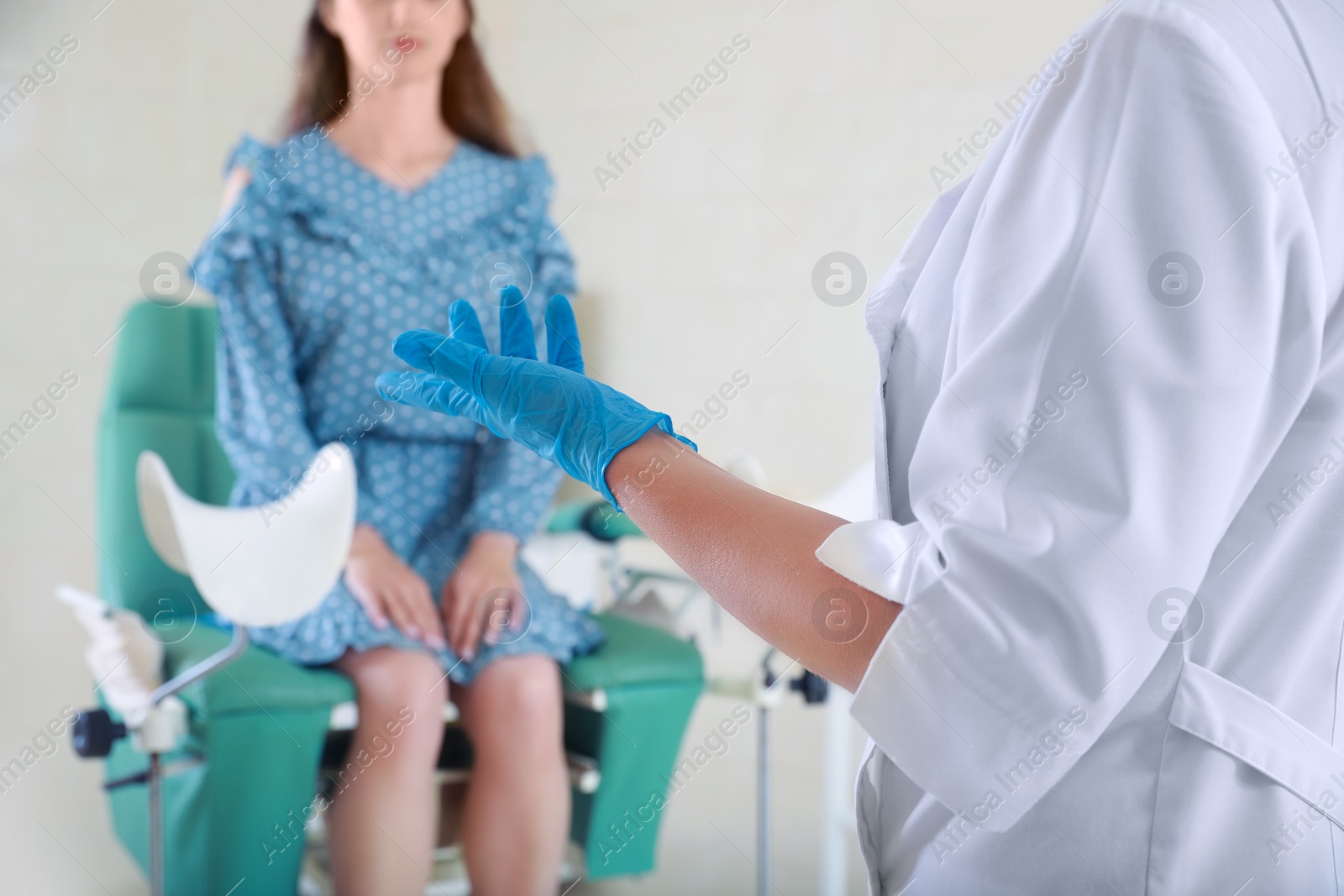 Photo of Woman having appointment with gynecologist in clinic, selective focus. Patient consultation