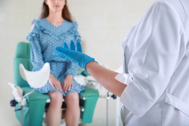 Woman having appointment with gynecologist in clinic, selective focus. Patient consultation