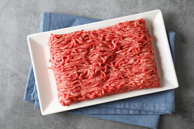 Raw ground meat on grey table, top view