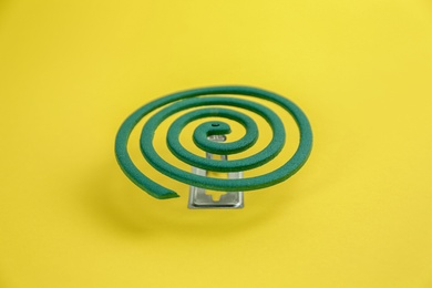 Photo of New insect repellent coil on yellow background
