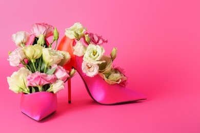 Photo of Stylish women's high heeled shoes with beautiful flowers on pink background, space for text