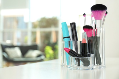 Organizer with makeup cosmetic products on table indoors. Space for text