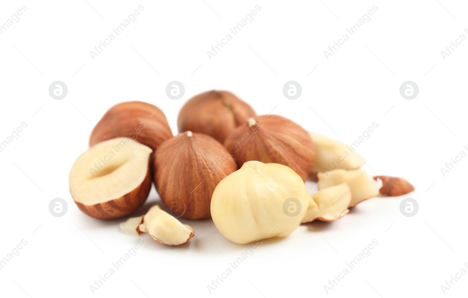 Photo of Heap of tasty hazelnuts on white background