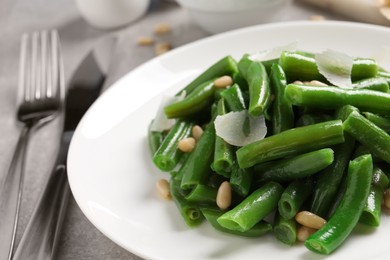 Tasty salad with green beans served on light grey table, closeup