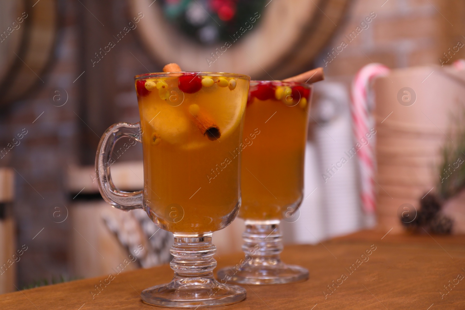 Photo of Tasty aromatic mulled wine on wooden table