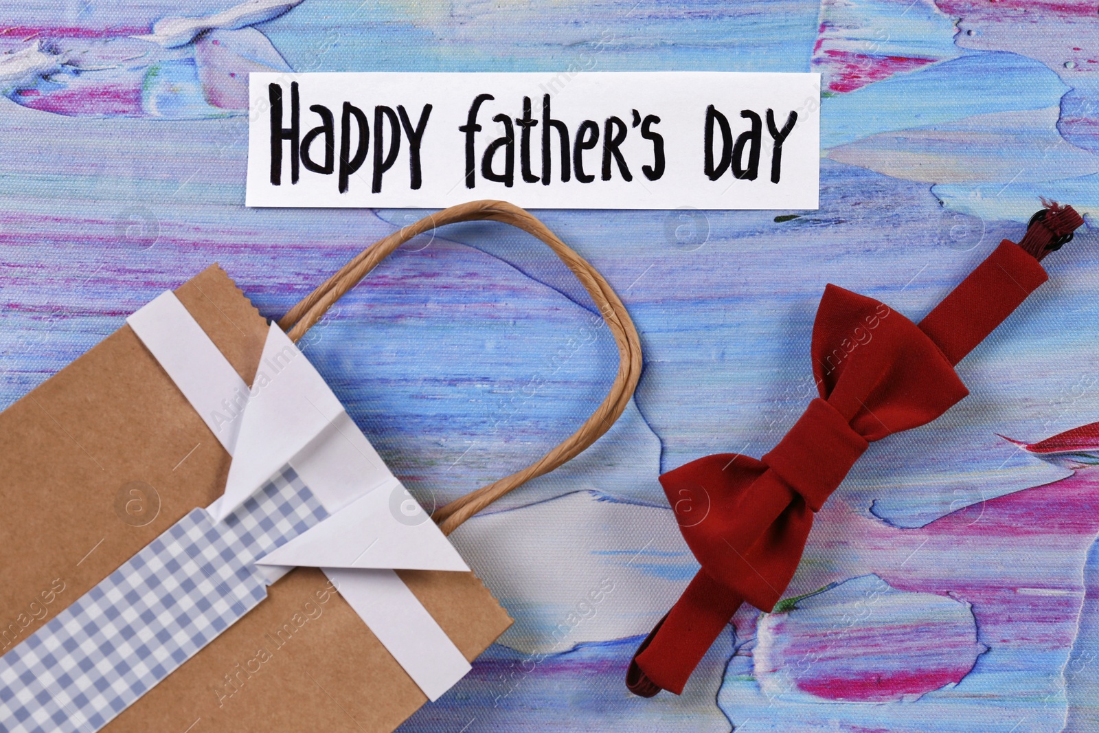 Photo of Bow tie and gift bag on color background. Father's day celebration