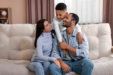 Happy international family on sofa at home