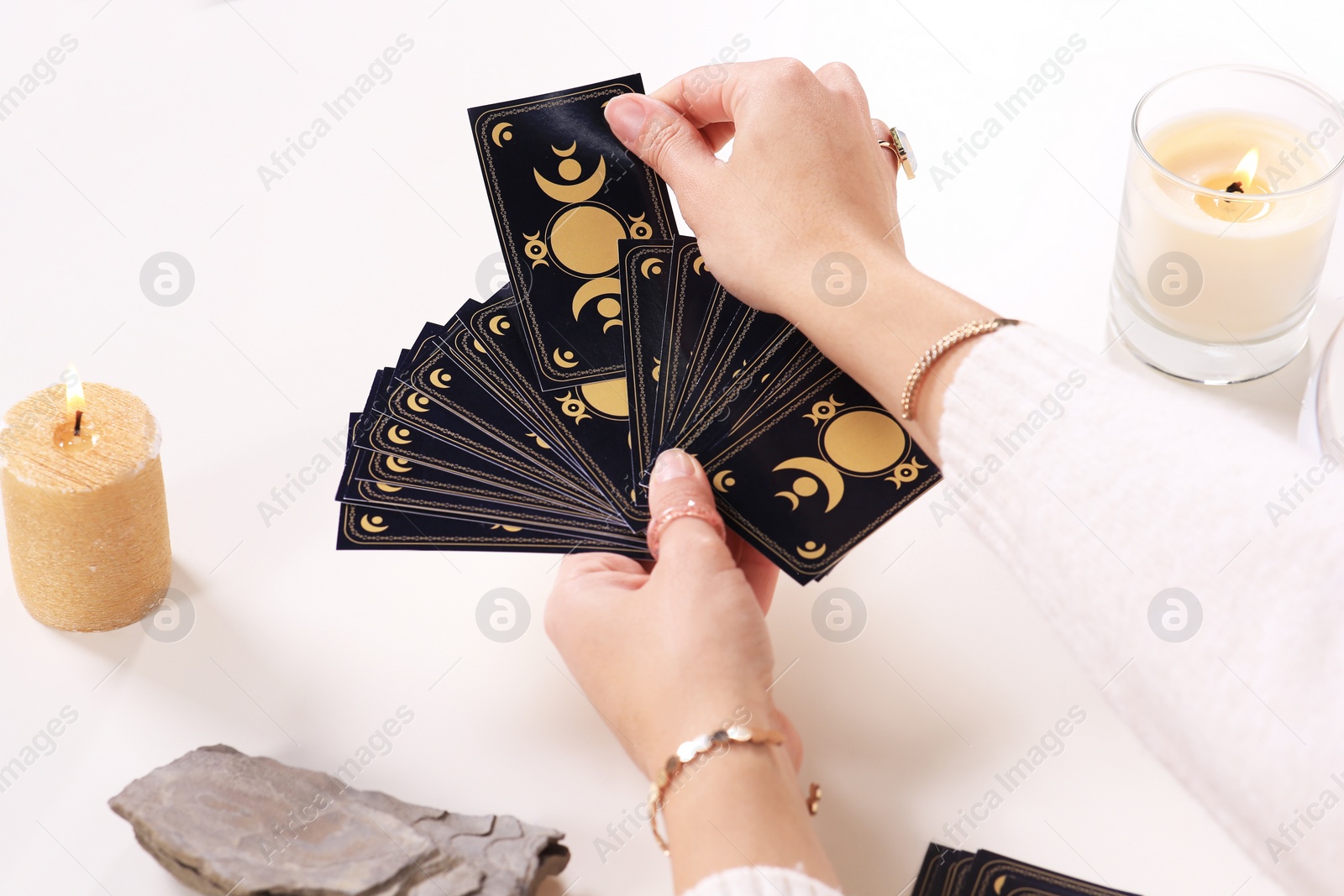 Photo of Soothsayer pulling one tarot card at table, closeup. Future telling