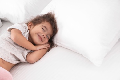 Photo of Cute little girl sleeping on bed. Space for text