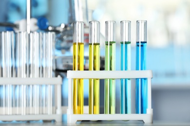 Test tubes with colorful liquids on table in laboratory