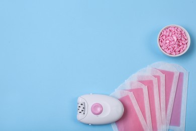 Photo of Set of epilation products on light blue background, flat lay. Space for text