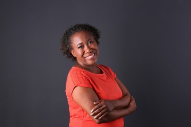 Photo of Portrait of happy African-American woman on black background