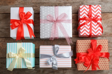 Photo of Different gift boxes on wooden background, flat lay