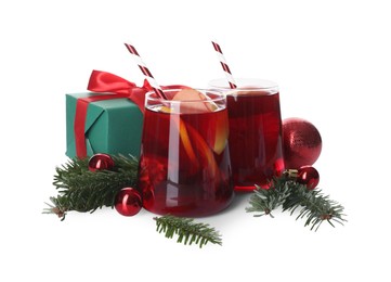 Photo of Delicious Sangria drink in glasses and Christmas decorations on white background