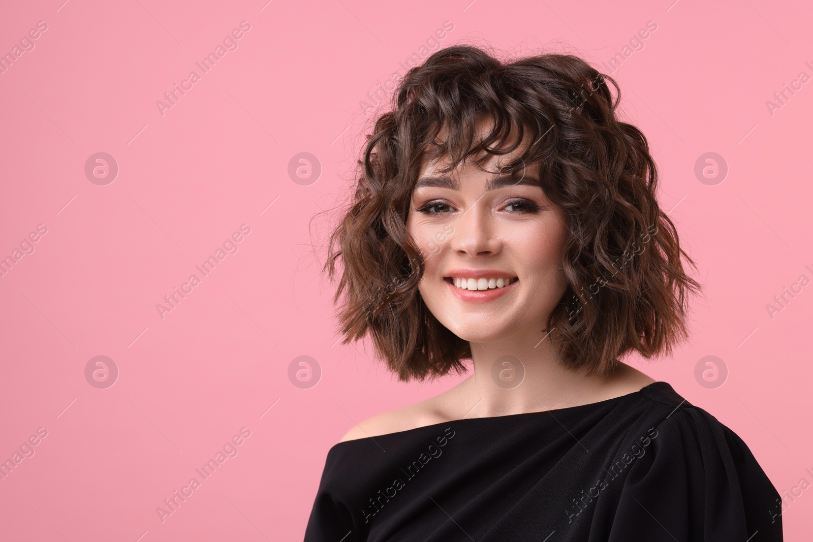 Photo of Portrait of beautiful young woman with wavy hairstyle on pink background. Space for text