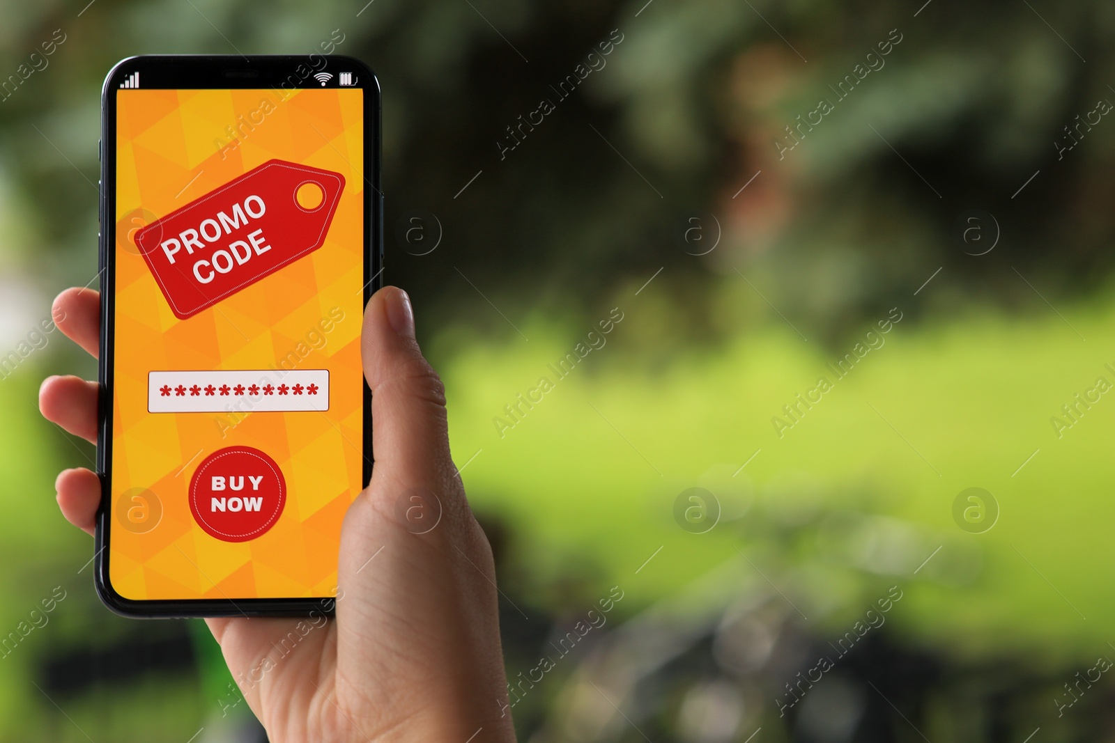 Photo of Woman holding smartphone with promo code on blurred background, closeup. Space for text