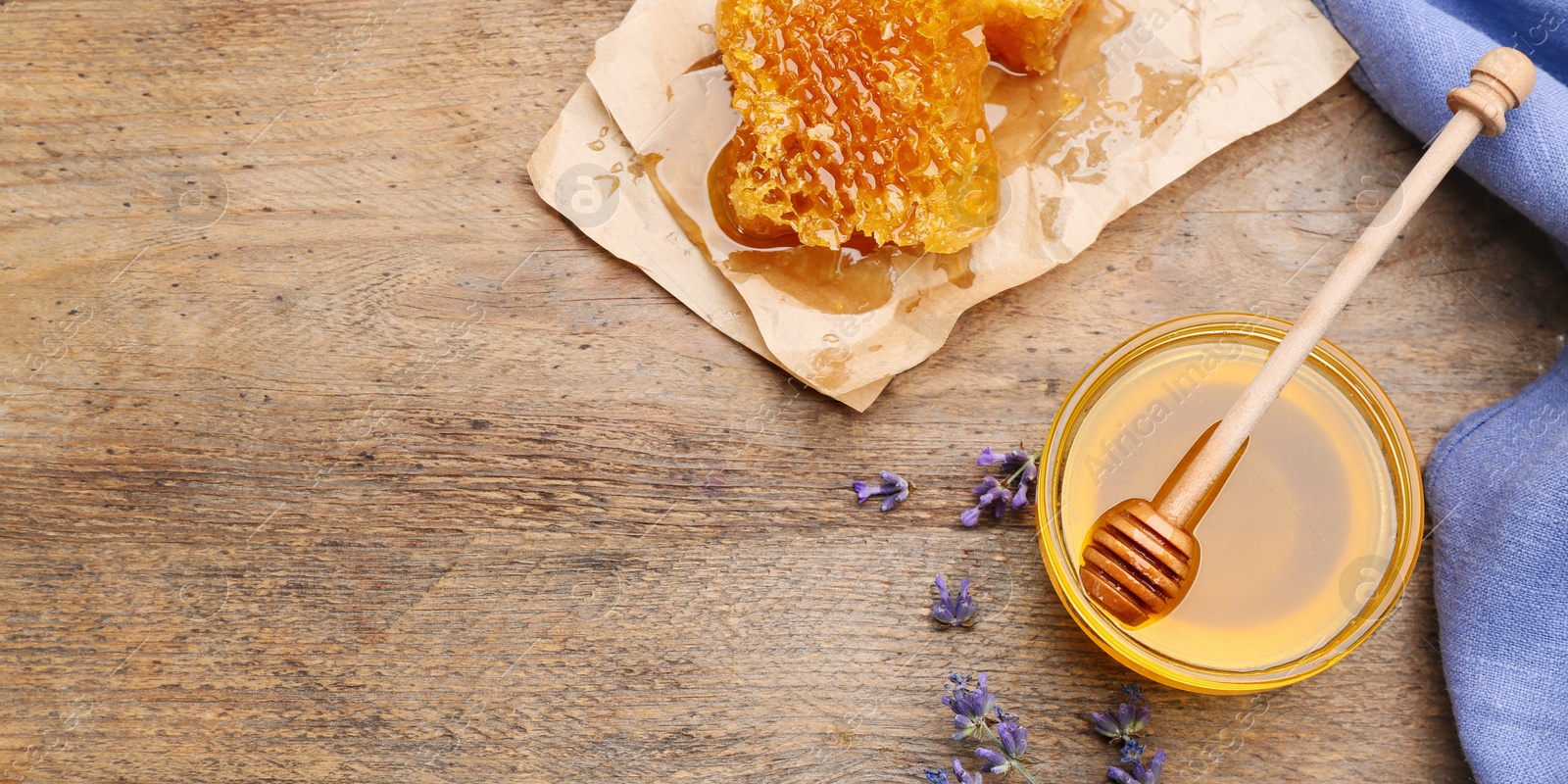 Photo of Flat lay composition with tasty honey on wooden table. Space for text