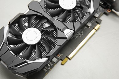 Computer graphics card on gray textured background, above view