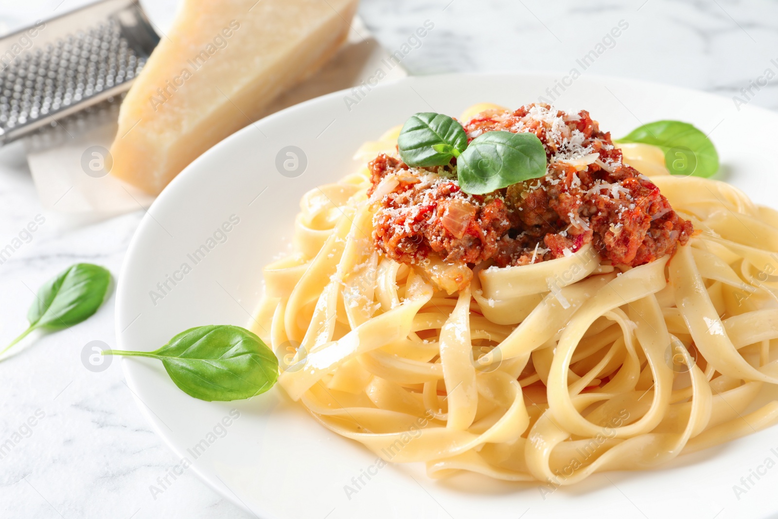 Photo of Plate with delicious pasta bolognese on table