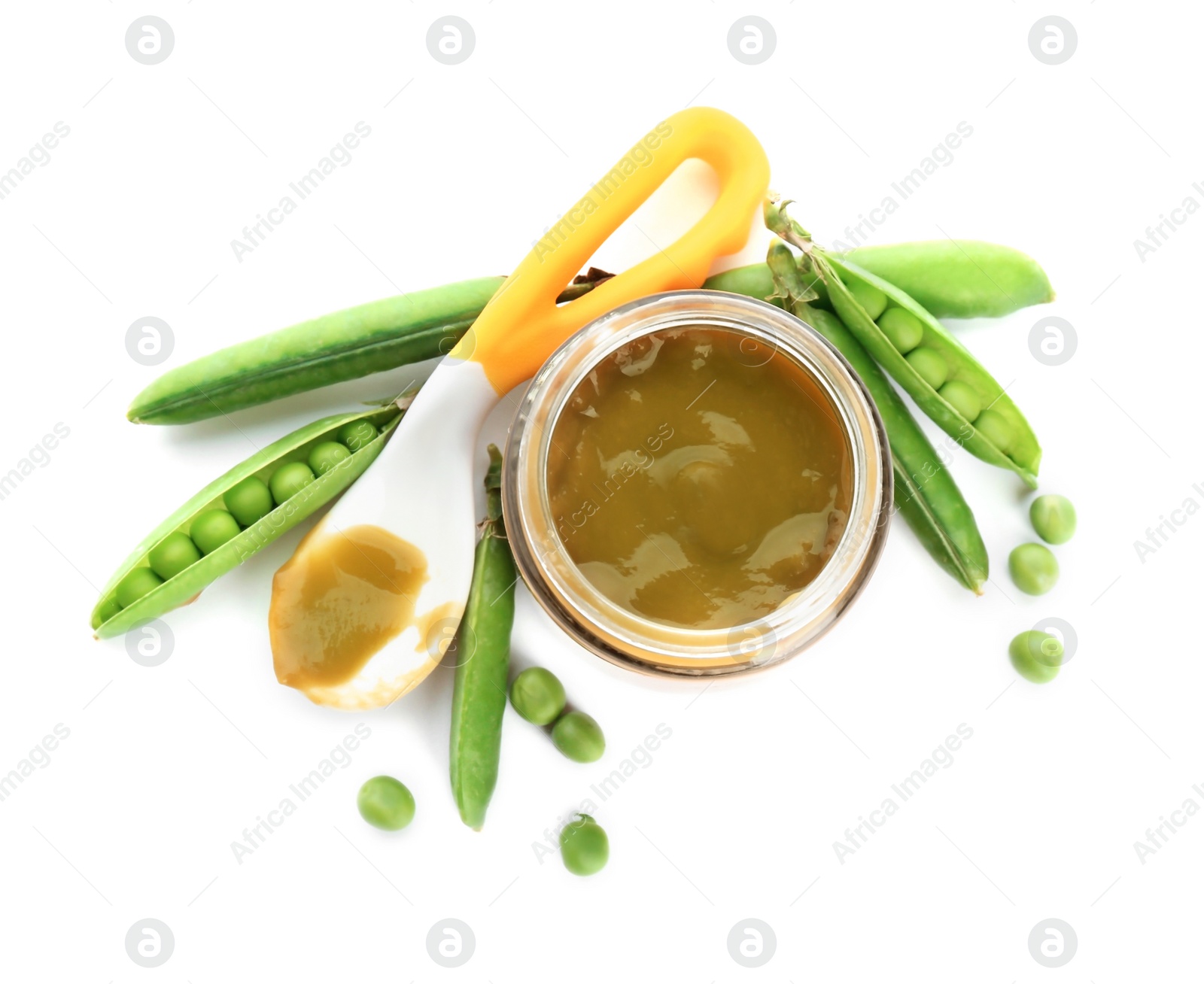 Photo of Jar with healthy baby food and green peas on white background, top view