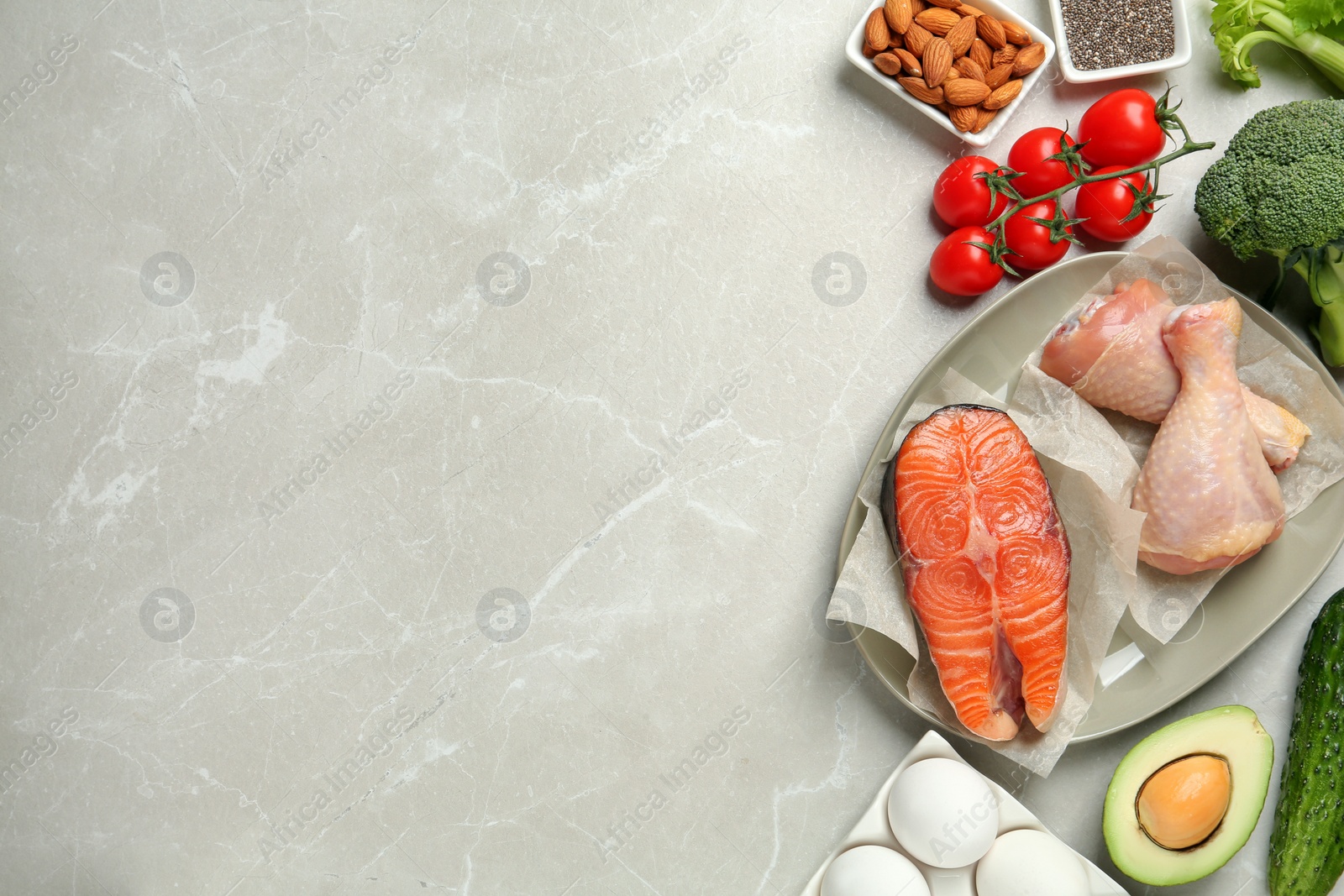 Photo of Flat lay composition with keto diet products on light grey marble table, space for text